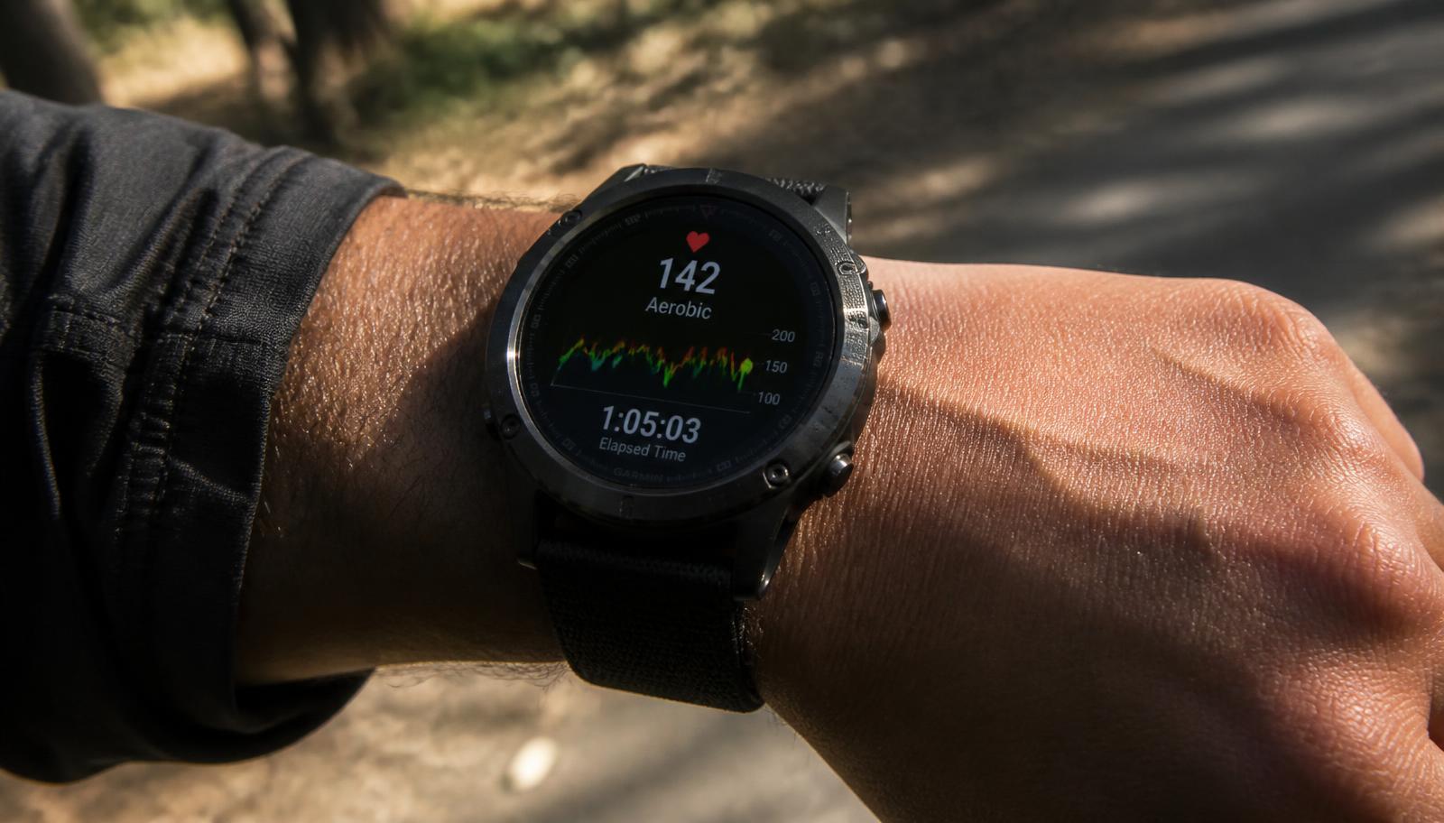 A sports smartwatch on a wrist during an outdoor walk